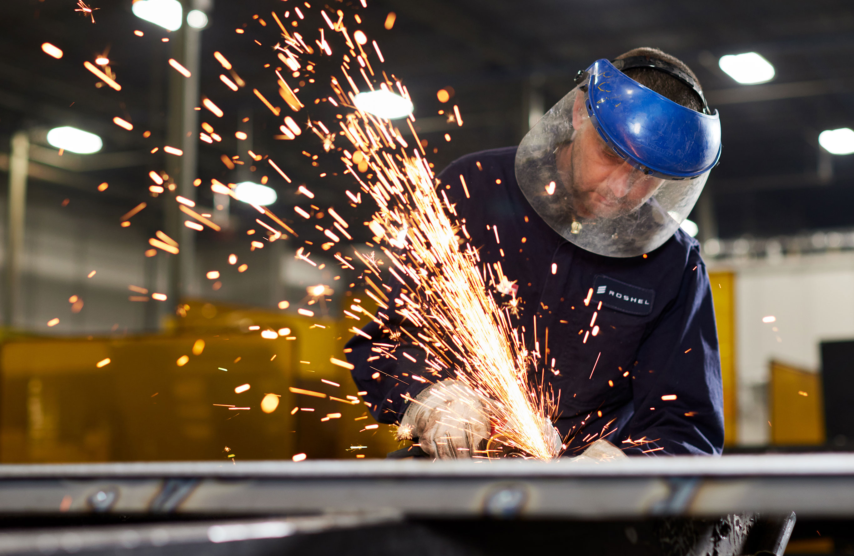 Header Image. Man showered by sparks from an angle grinder